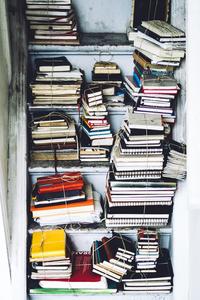 A cupboard full of used notebooks